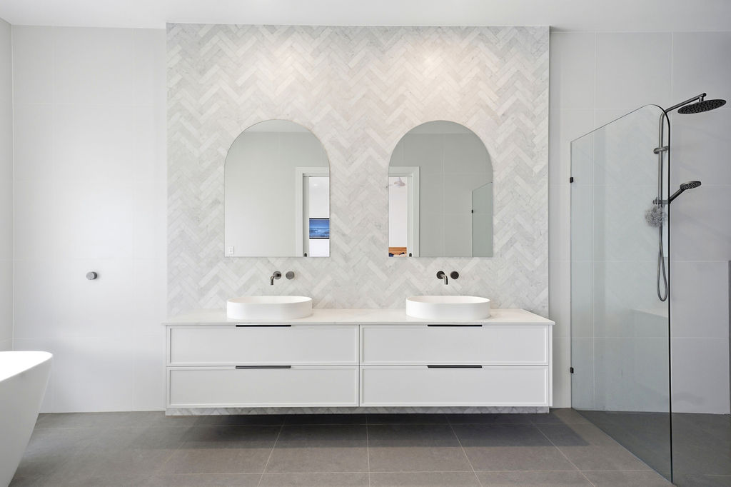 Ensuite with herringbone marble tile and double vanity