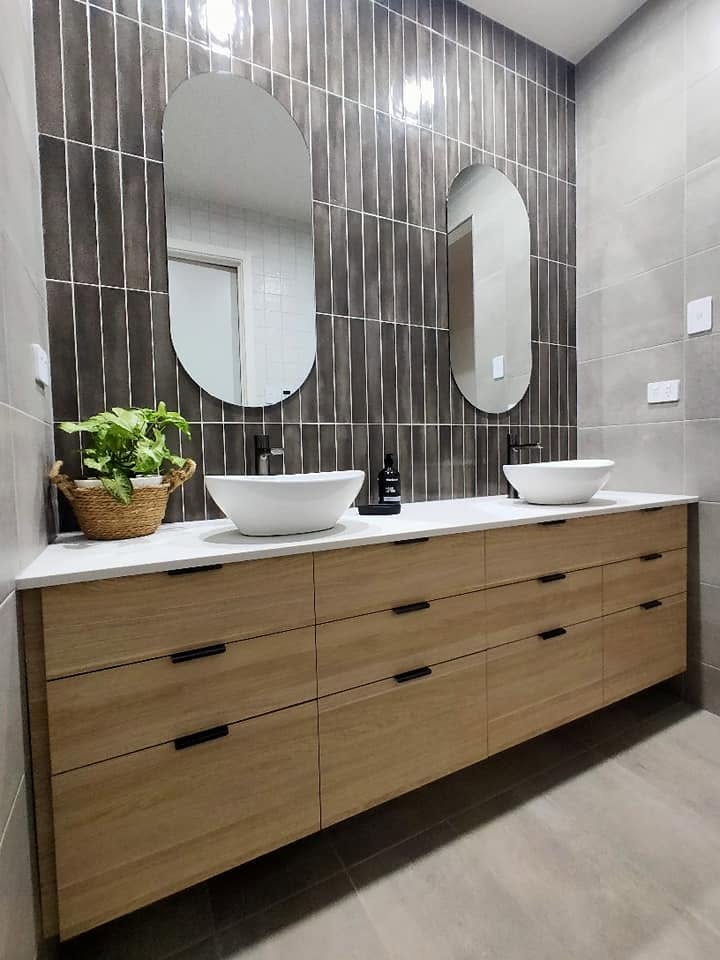 Timber double vanity with vessel basins and arched mirrors