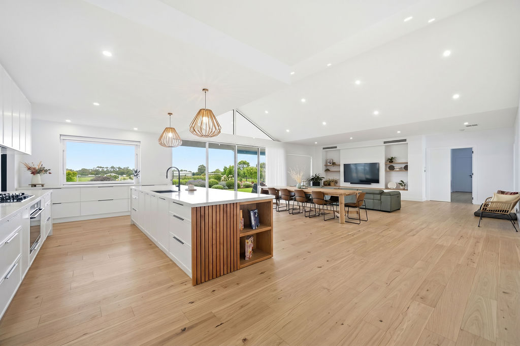 Open plan kitchen with timber island and pendant lights