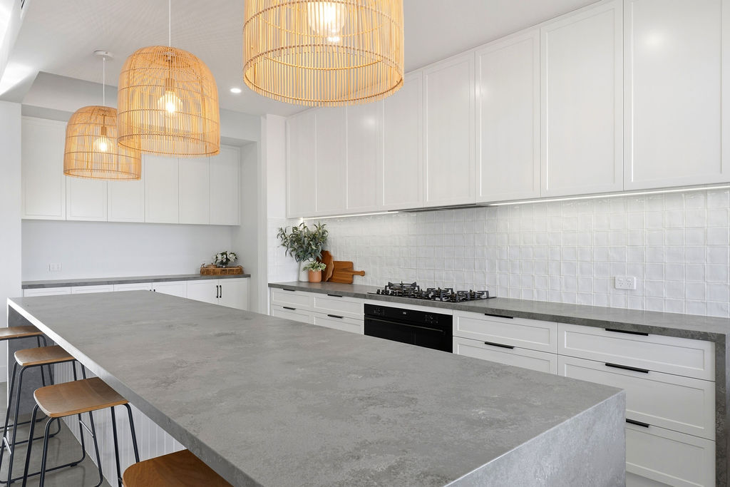 Shaker kitchen with concrete benchtop and rattan pendants